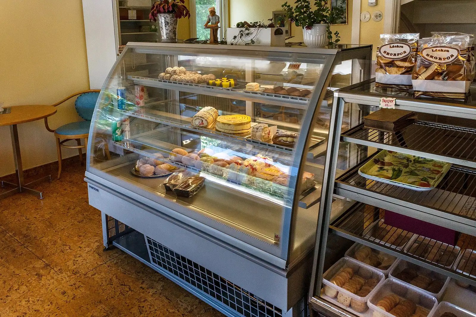 Display cases of cakes and pastries inside a bakery in Sweden.