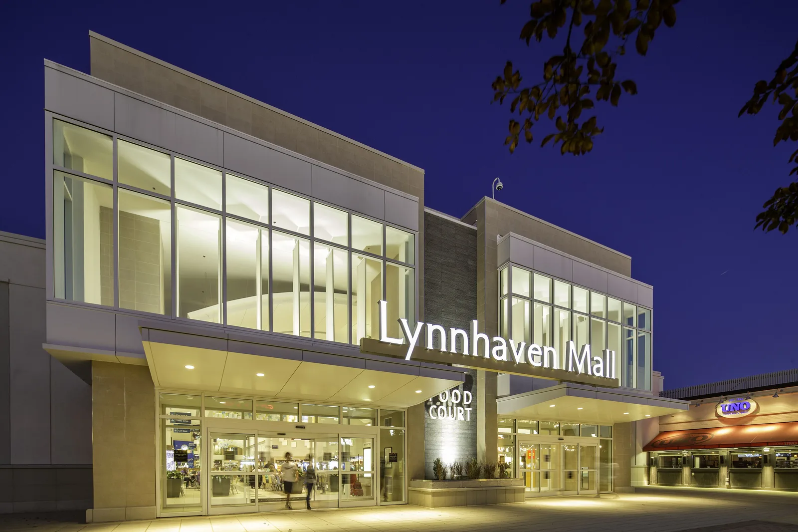 The food court entrance of Lynnhaven Mall on Lynnhaven Parkway in Virginia Beach, lit up at dusk.