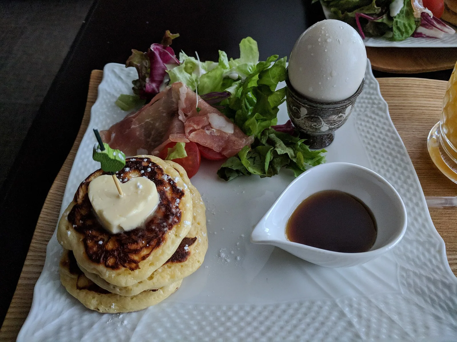 Pancakes, a soft-boiled egg and salad on a hotel breakfast plate in Kyoto, Japan.