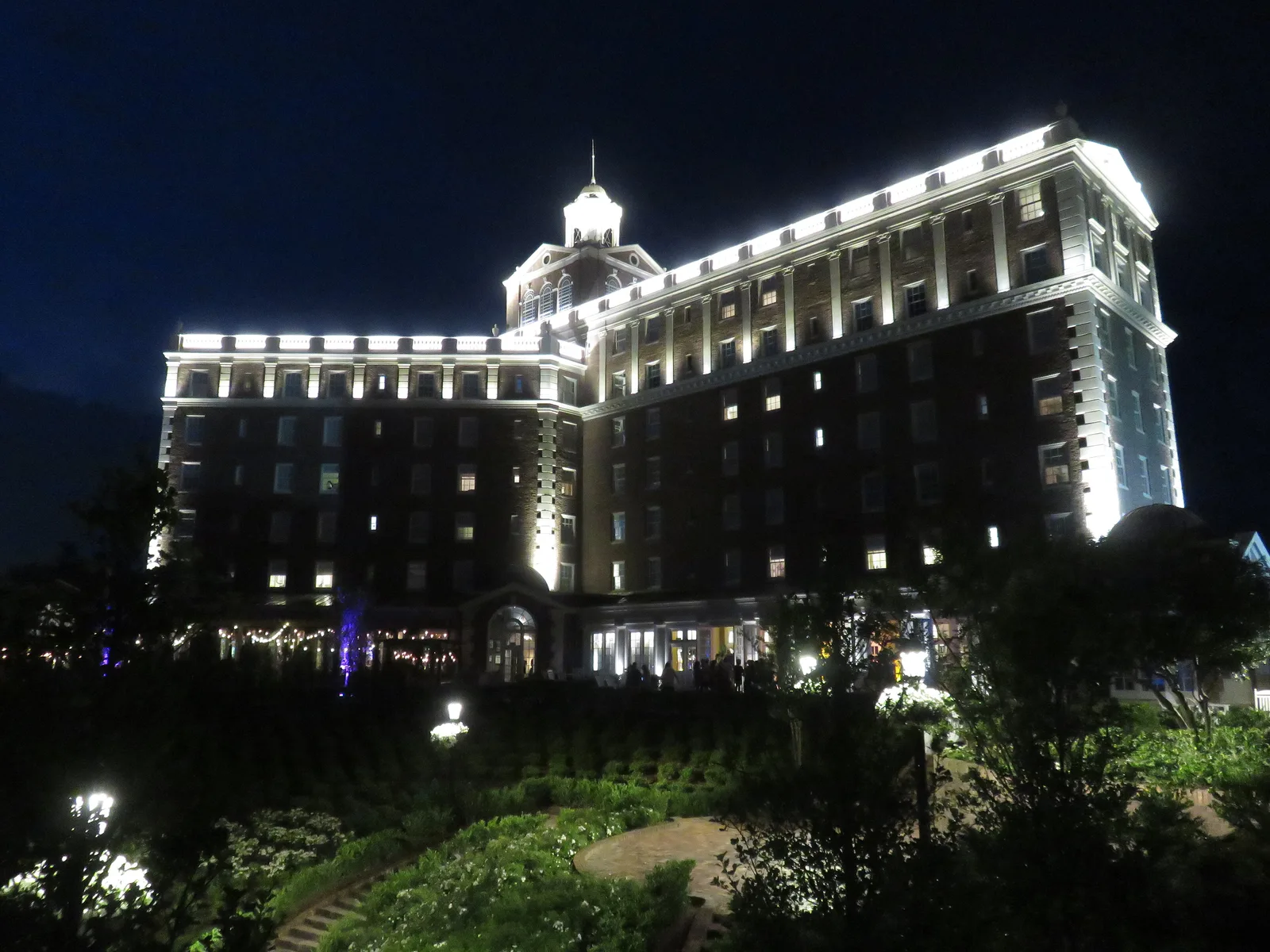 The Historic Cavalier Hotel lit up at night above its gardens on Atlantic Avenue in Virginia Beach.