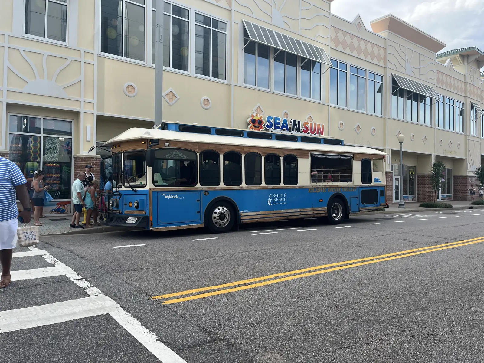 A VB Wave Atlantic Avenue Trolley picking up riders at the Virginia Beach Oceanfront.