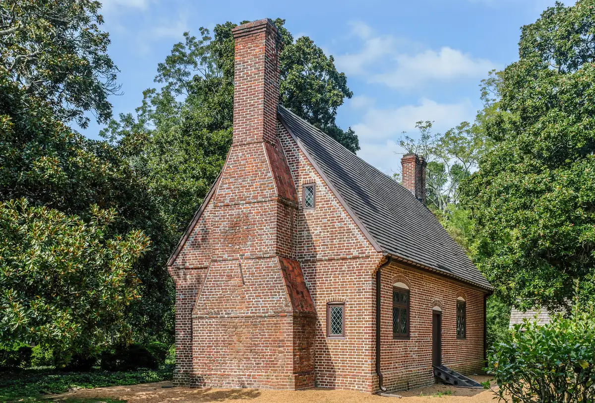 The brick Adam Thoroughgood House on Parish Road in Virginia Beach, where costumed guides lead Candlelight Yule Tours in December.