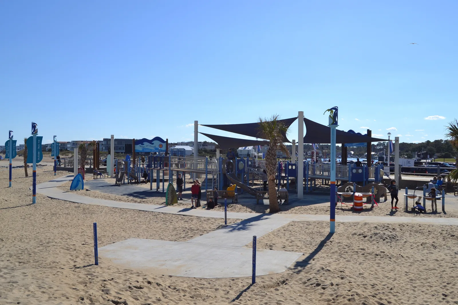The shaded, fully accessible playground at Grommet Island Park on the sand at the Boardwalk and 2nd Street in Virginia Beach.