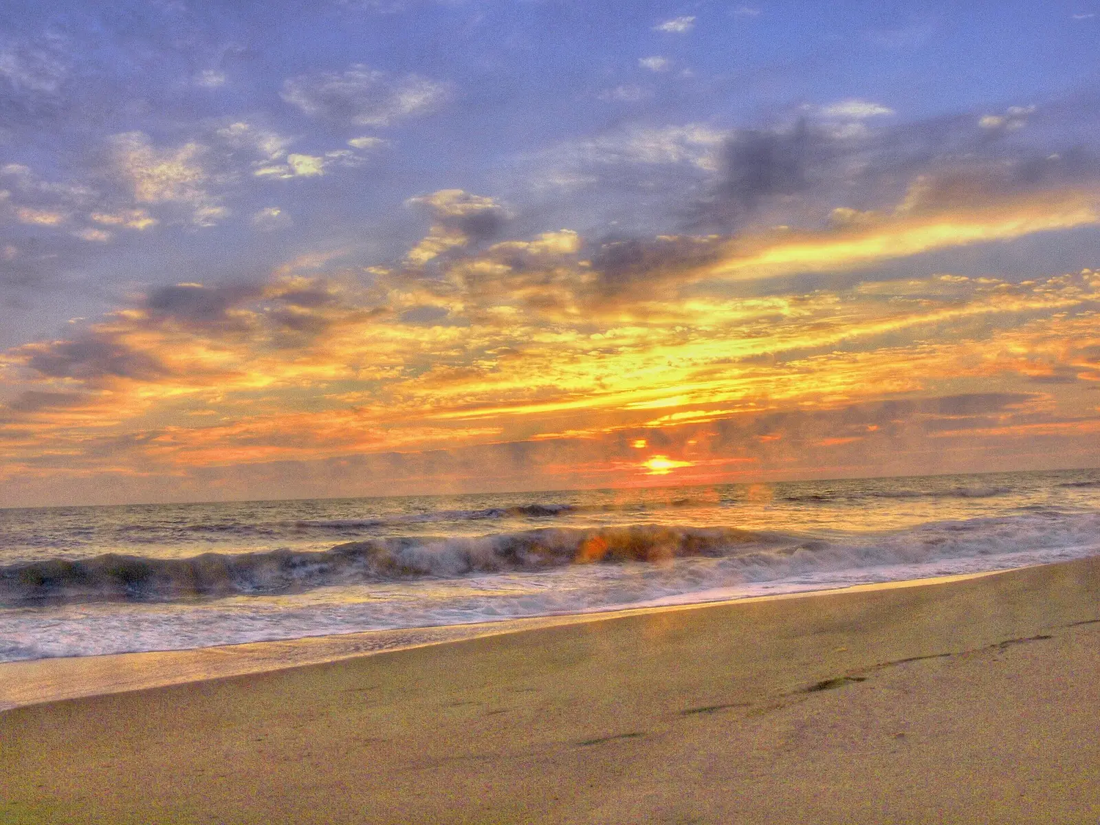 The sun low over the Atlantic Ocean at Sandbridge Beach in Virginia Beach.