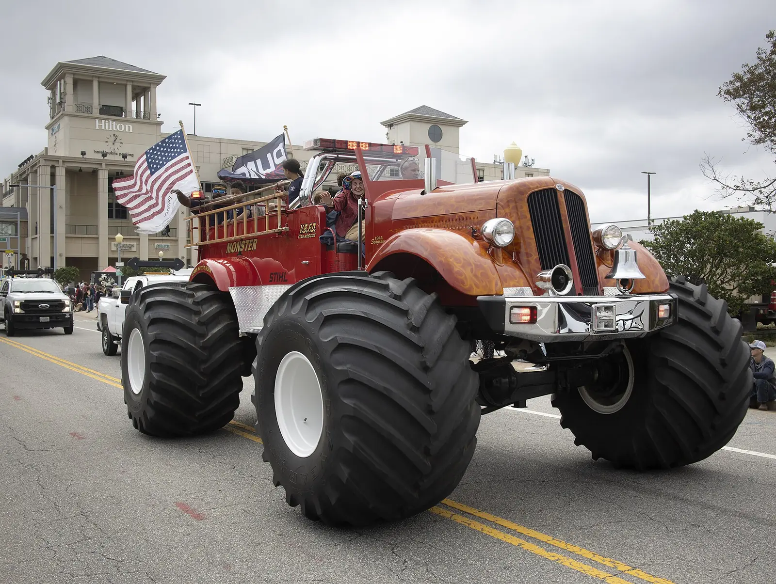 A monster fire truck carries riders down Atlantic Avenue during the Neptune Festival at the Virginia Beach Oceanfront.