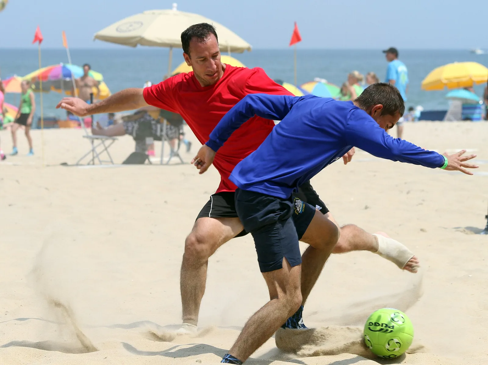 Two players fight for the ball during a sand soccer match on the Virginia Beach Oceanfront.