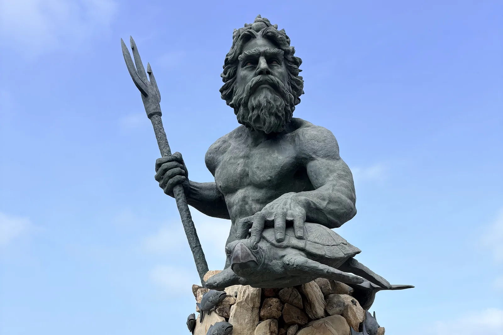 The bronze King Neptune statue, holding a trident and a sea turtle, on the Boardwalk at the Virginia Beach Oceanfront.
