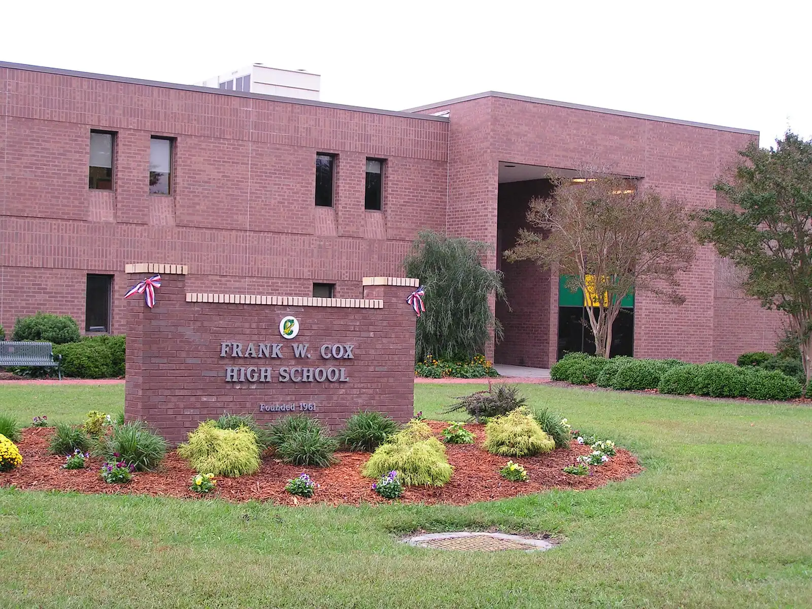 An entrance to Cox High School on Shorehaven Drive in Virginia Beach, with a plaque in the foreground.