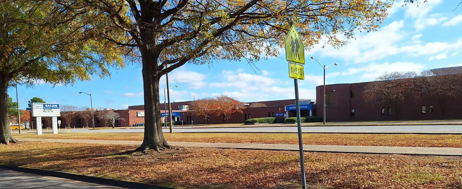 Salem Middle School on a fall afternoon in Virginia Beach, with its sign and a school crossing sign out front.