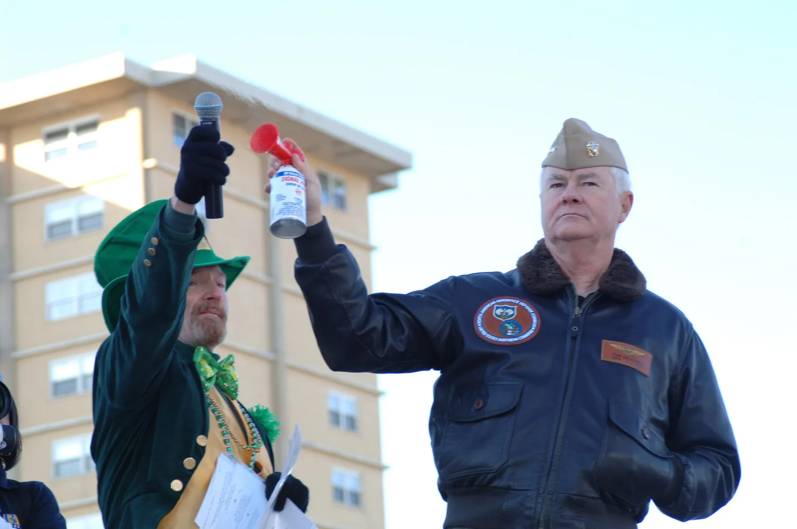 A leprechaun-costumed announcer and a Navy admiral sound the air horn to start the Shamrock Marathon at the Virginia Beach Oceanfront.