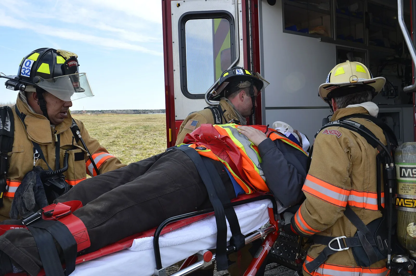 Firefighters load a drill participant into an ambulance during a joint Navy and Virginia Beach exercise at Naval Air Station Oceana. The picture does not show Virginia Beach EMS.