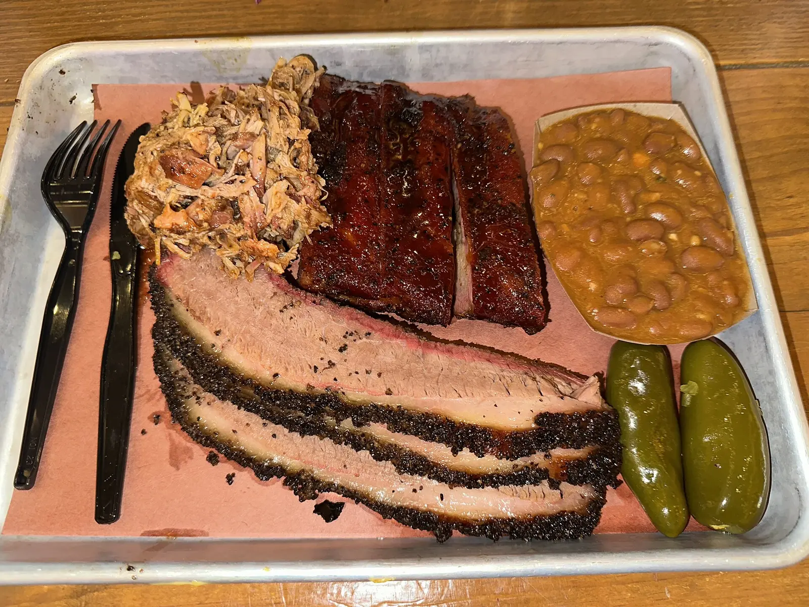 A plate of brisket, ribs, pulled pork and beans at a barbecue restaurant in San Antonio, Texas.