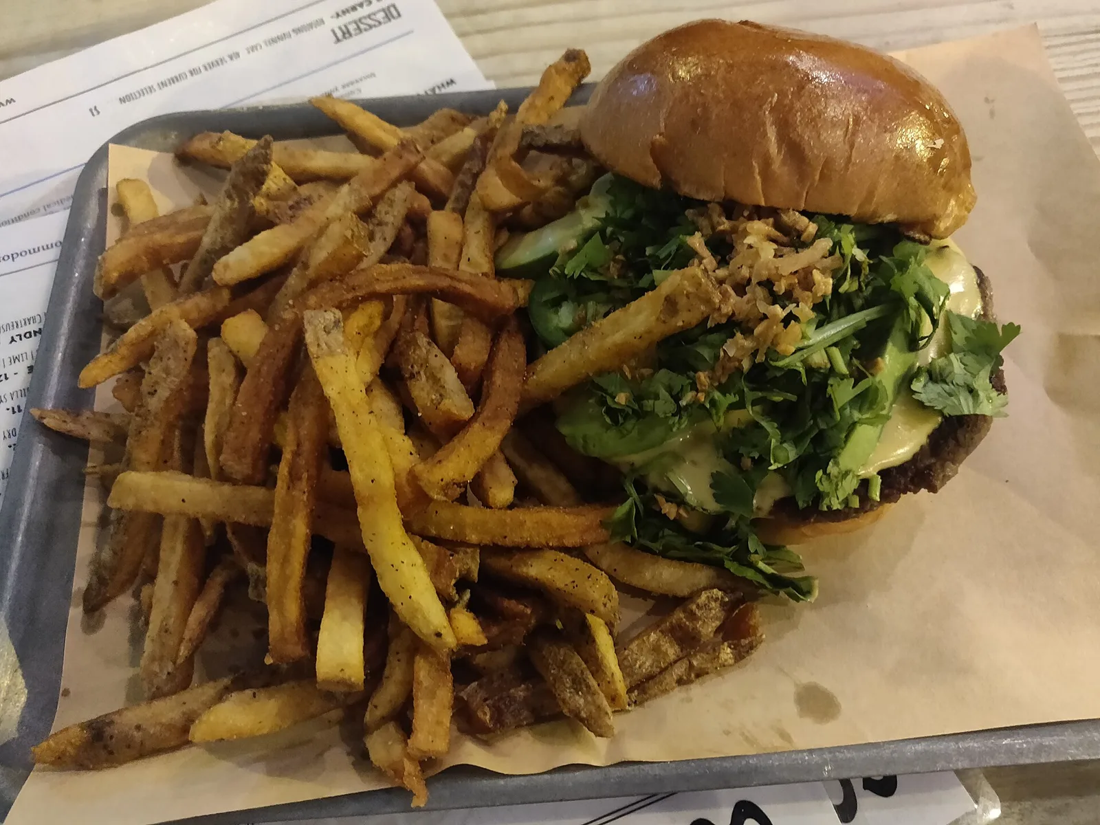 A cheeseburger with fries on a plate.